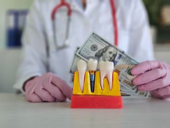 Dentist explaining dental implant costs